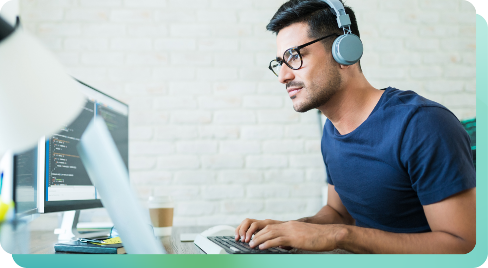 Man researching music licensing for businesses on computer with headphones on